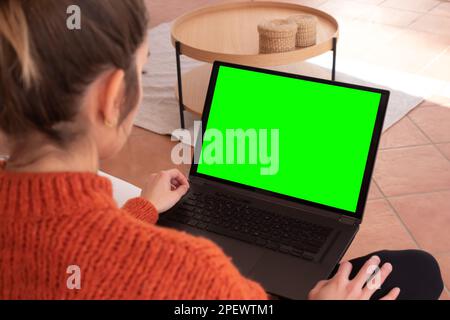 Anonymous female patient speaking with medical practitioner while having video chat on laptop during online consultation at home Stock Photo