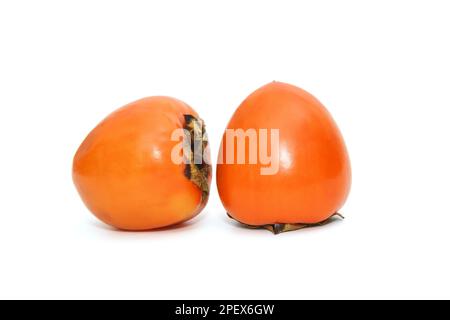 Two ripe persimmons isolated on a white background Stock Photo