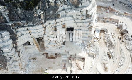 Heavy machines working at a huge marble quarry in Europe. Transporting the marble blocks. Stock Photo