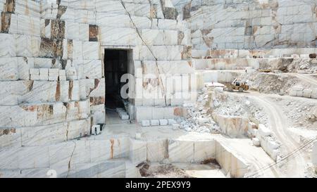 Heavy machines working at a huge marble quarry in Europe. Transporting the marble blocks. Stock Photo