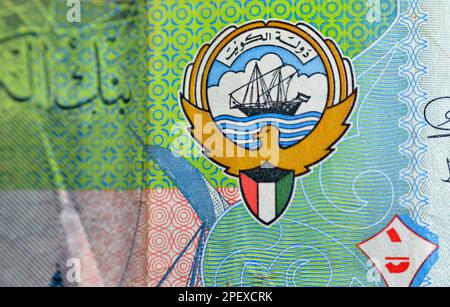 The coat of arms and flag of Kuwait closeup from the obverse side of Kuwaiti half dinar green paper banknote cash money bill currency also features Th Stock Photo