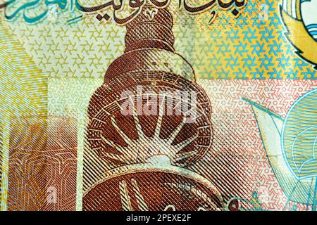 The Liberation Tower closeup from obverse side of Kuwaiti quarter dinar brown paper banknote cash money bill currency that also features a dhow ship Stock Photo