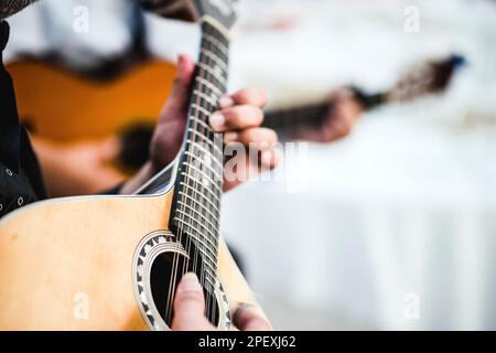 Close up of the guitar of a man playing traditional Portuguese music called fado Stock Photo