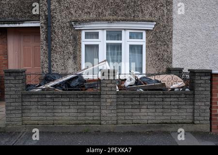 Building debris and rubbish is piled in the front garden of a terraced house undergoing renovation in East London, UK, Dec. 2020. Stock Photo