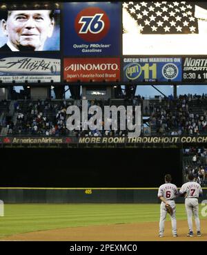 Montreal Expos former pitcher and now coach Claude Raymond, left, consoles  Brad Wilkerson as they say farewell to fans following the team's final home  game against the Florida Marlins in Montreal, Sept.