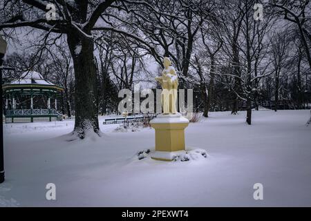 The Statue Ceres, goddess of agriculture, grain crops and fertility in Halifax Public Gardens National Historic Site of Canada in the depths of winter Stock Photo