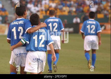 Mauricio Cienfuegos of the Los Angeles Galaxy, left, fights for