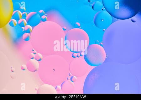 Bright abstract, multicolored background with oil circles.With blue, lilac, pink, yellow and beige color. Stock Photo