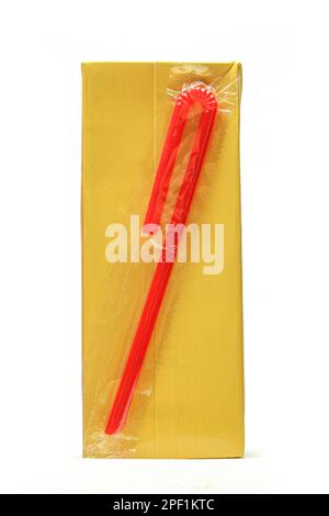 Carton juice box with red plastic straw attached isolated on white background Stock Photo