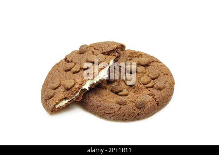 Chocolate chip cookies filled with milk cream isolated on white background. Whole and broken biscuits Stock Photo