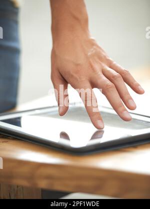 Business at the touch of a button. a businessmans hand touching the screen on a digital tablet. Stock Photo