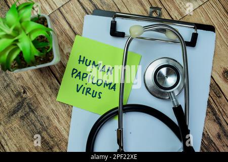 Concept of Human Papiloma Virus write on sticky notes isolated on Wooden Table. Stock Photo