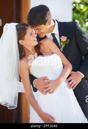 The love of his life. A handsome groom dipping his gorgeous bride and looking into her eyes. Stock Photo