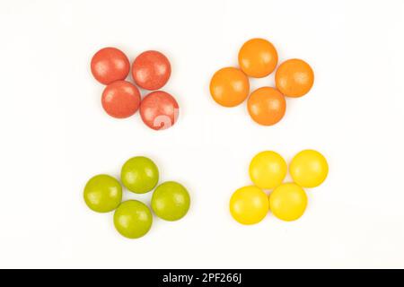 Four groups of colored drops isolated on white background. Mint flavoured candies Stock Photo