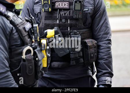 England, London, Westminster, Downing Street, Detail of AFO Police officers wearing body protection with radio, taser gun and handcuffs. Stock Photo
