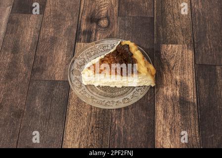 A wonderful serving of creamy cheesecake on transparent glass plate Stock Photo