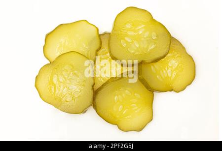Pile of sliced pickles isolated on white background. Cucumber pieces slices Stock Photo