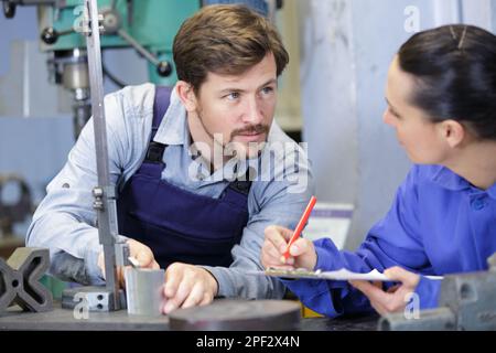 man and woman with machine cnc Stock Photo