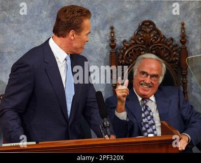 Gov. Arnold Schwarzenegger left turns and smiles as State Sen