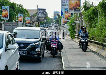 Malang, East Java, Indonesia. 16th Mar, 2023. People stuck in traffic jams during rush hour in Malang. The Indonesian National Police (Polri) noted that the number of motorized vehicles in Indonesia reached 152.51 million units as of December 31 2022. Of these, 126.99 million units or 83.27% of them in the form of a motorcycle. A total of 19.31 million motorized vehicles in Indonesia are passenger cars. (Credit Image: © Moch Farabi Wardana/Pacific Press via ZUMA Press Wire) EDITORIAL USAGE ONLY! Not for Commercial USAGE! Stock Photo