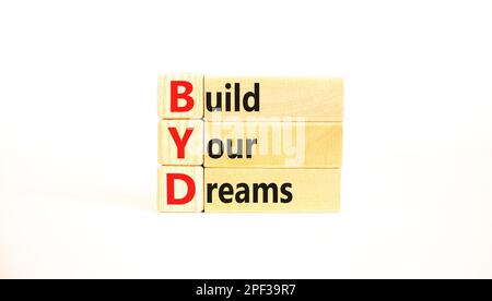 BYD build your dreams symbol. Concept words BYD build your dreams on wooden blocks on a beautiful white table white background. Business and BYD build Stock Photo