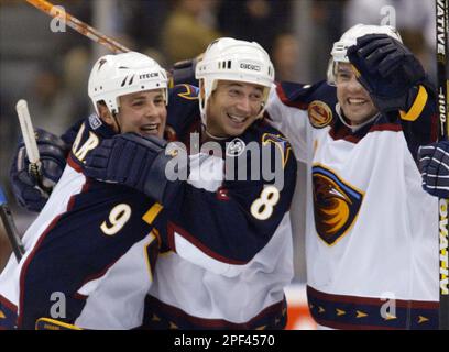 Newly acquired Ottawa Senators' Peter Bondra, right, is closely guarded by  Atlanta Thrashers' Marc Savard during second-period NHL action in Ottawa on  Thursday, Feb.19, 2004. (AP Photo/Simon Hayter Stock Photo - Alamy