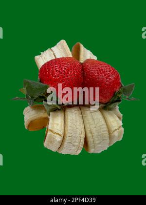 Display fresh strawberries on banana skin peel to make a table display using a mirrored image. Show a decorative arrangement. Use this isolated image. Stock Photo