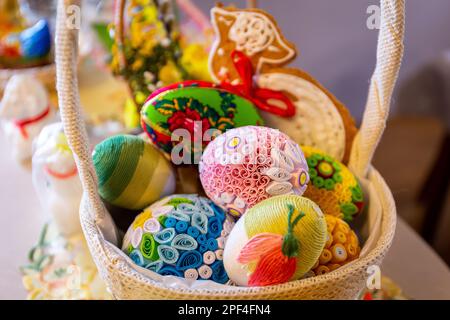 Traditional Easter basket with colorful handmade Easter origami eggs and gingerbread Easter lamb. Stock Photo