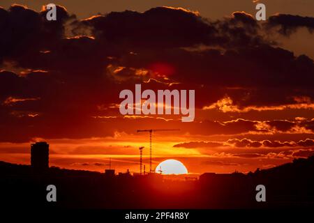 Sunset, building crane in front of dark clouds, Stuttgart, Baden-Wuerttemberg, Germany Stock Photo
