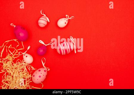 Easter eggs on red background with negative space for copy placement Stock Photo
