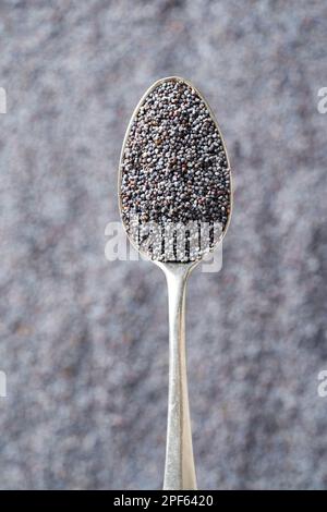 Poppy seeds on a metal spoon, top view Stock Photo