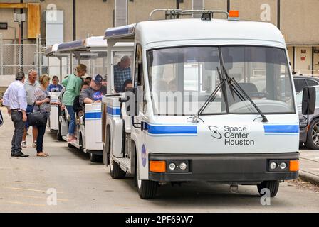 Houston, Texas, USA - February 2023: Visitors to the Houston Space Center getting on a land train for a tour of the site Stock Photo