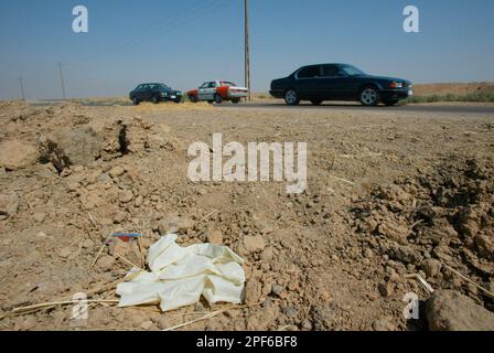 A pair of protective rubber gloves mark the place, Sunday June 29, 2003,  where the remains of two missing soldiers were found 32 kilometers (20  miles) northwest of Baghdad on Saturday. Sgt.