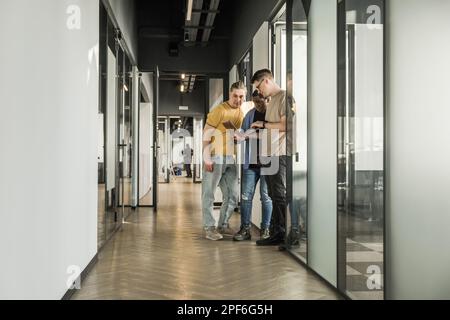 Team is looking for bug fixes in the phone application. Programmers working in the office of a software development company. Coding technologies, site Stock Photo