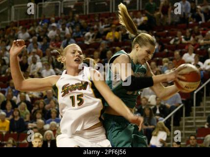 Minnesota Lynx s Michele Van Gorp right grabs a rebound past