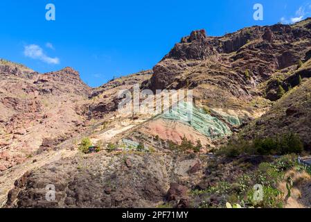 Monumento Natural Azulejos de Veneguera, also known as Rainbow Rocks in Mogán, Las Palmas, Gran Canaria, Spain. Stock Photo