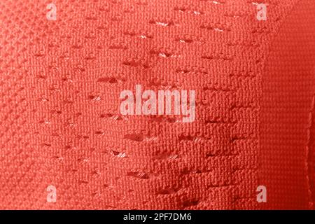 Closeup view of coral knitted fabric texture as background Stock Photo
