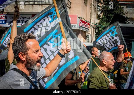 Bnei Brak, Israel. 16th Mar, 2023. Members of the Brothers in Arm reserve soldiers movement hold flags during a protest against the Judicial reform in the Ultra orthodox city of Beni Brak east of Tel Aviv. Israeli protesters held demonstrations against a contentious government plan to overhaul the judiciary, pushing back against Prime Minister Benjamin Netanyahu after he rejected a compromise proposal that was meant to defuse the crisis. (Photo by Eyal Warshavsky/SOPA Images/Sipa USA) Credit: Sipa USA/Alamy Live News Stock Photo