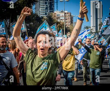 Bnei Brak, Israel. 16th Mar, 2023. Members of the Brothers in Arm reserve soldiers movement gesture during a protest against the Judicial reform in the Ultra orthodox city of Beni Brak east of Tel Aviv. Israeli protesters held demonstrations against a contentious government plan to overhaul the judiciary, pushing back against Prime Minister Benjamin Netanyahu after he rejected a compromise proposal that was meant to defuse the crisis. (Photo by Eyal Warshavsky/SOPA Images/Sipa USA) Credit: Sipa USA/Alamy Live News Stock Photo