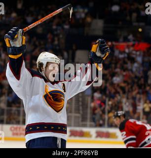 Atlanta Thrashers right wing Dany Heatley, right, hits the puck