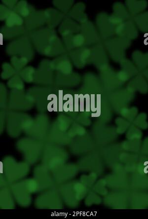 Blurred green clovers on the dark background. Abstract background. Stock Photo