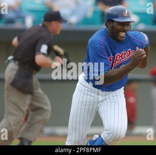 Montreal Expos' Vladimir Guerrero, right, swings for a homerun to  left-center in the sixth inning of the second game of a day-night  doubleheader against Cincinnati Reds at the Hiram Bithorn Stadium in