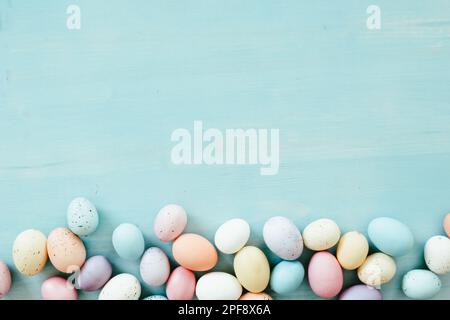 Border of easter eggs on a blue wood background with copy space Stock Photo