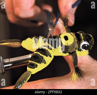 https://l450v.alamy.com/450v/2pf98x2/advance-for-sunday-feb-2-fly-fishing-lure-maker-jim-reed-works-on-a-lure-at-his-home-in-howell-mich-jan-5-2003-it-can-take-up-to-six-hours-to-hand-tie-some-of-his-more-intricate-lures-ap-photolivingston-county-daily-press-argus-alan-ward-2pf98x2.jpg