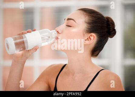 With magic soaking my spine. a ballet dancer taking a water break between dance routines. Stock Photo