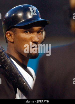 Florida Marlins' Juan Pierre is congratulated by teammate Derrek