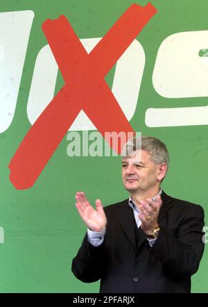 German Foreign Minister Joschka Fischer of the Green Party stands in front of a poster showing a ' cross' through the o in his first name, prior his speech at an election campaign in Hamburg, northern Germany, on Tuesday, Sept. 17, 2002. The German general elections will be held on Sunday, Sept. 22. (AP Photo/Fabian Bimmer)
