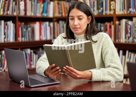 Without a librarian, it is but an empty shell. a young female student reading in a library. Stock Photo