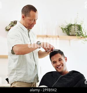 Father, man and shaving hair in home for grooming, cleaning and trimming. Smile, laughing and happy male or son getting haircut with electric shaver Stock Photo