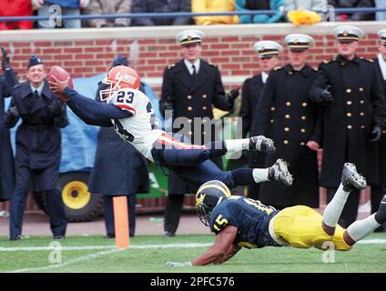 illinois-rocky-harvey-sails-into-the-end-zone-ahead-of-michigans-dewayne-patmon-to-put-illiniois-ahead-for-an-eventual-35-29-victory-on-oct-23-1999-at-ann-arbor-mich-the-unexpected-win-and-haveys-dive-has-been-memorialized-on-a-wide-variety-of-promotional-materials-since-last-season-the-teams-will-meet-again-this-saturday-sept-23-2000-ap-photothe-news-gazette-darrell-hoemann-2pfc576.jpg